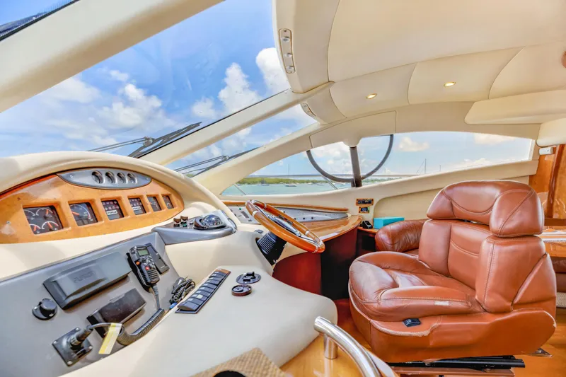  Yacht Photos Pics Luxurious 2005 Azimut 55E yacht interior with leather seating and modern dashboard.