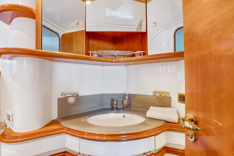  Yacht Photos Pics Luxurious bathroom interior of 2005 Azimut 55E yacht with elegant wood accents.