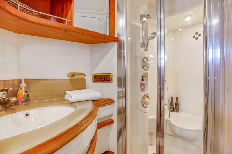  Yacht Photos Pics Luxurious bathroom in a 2005 Azimut 55E yacht with modern fixtures and wooden accents.