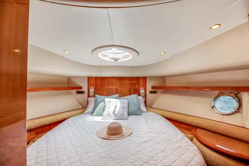  Yacht Photos Pics Luxurious cabin interior of a 2005 Azimut 55E yacht with elegant bedding and wood accents.