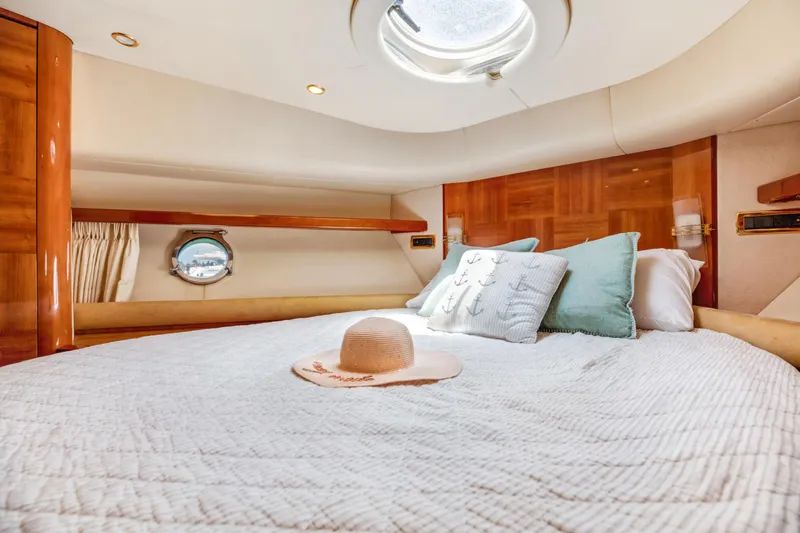  Yacht Photos Pics Luxurious bedroom interior of 2005 Azimut 55E yacht with elegant bedding and decor.