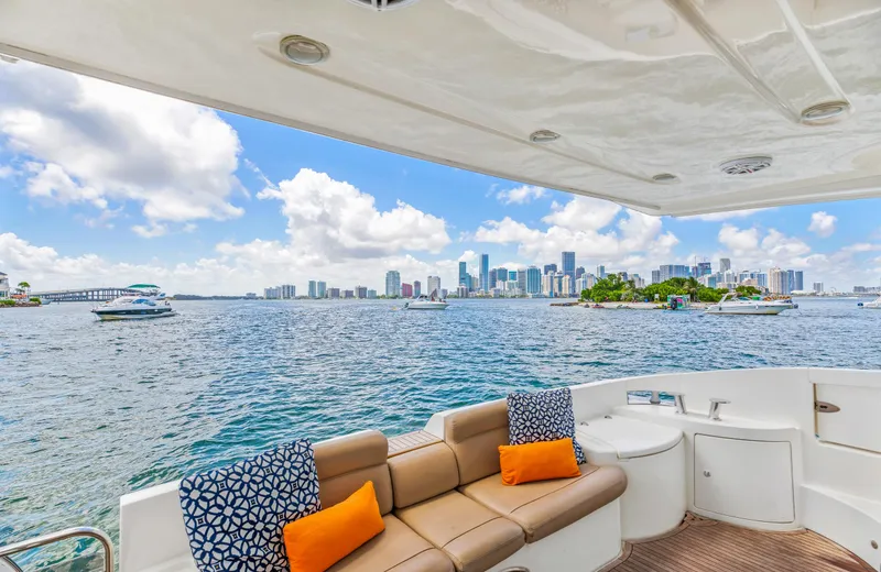  Yacht Photos Pics 2005 Azimut 55E yacht with city skyline view, featuring comfortable seating and vibrant cushions.