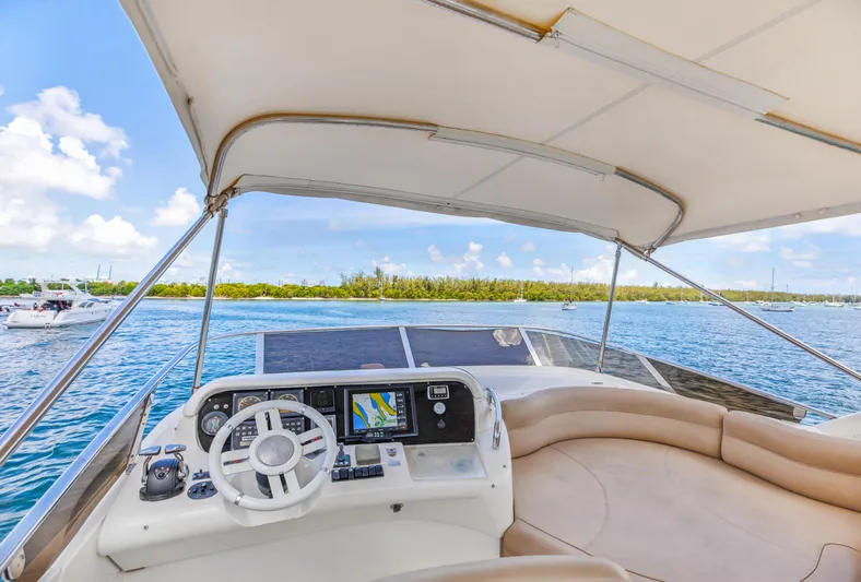  Yacht Photos Pics Cockpit view of 2005 Azimut 55E yacht on a sunny day, featuring navigation equipment.