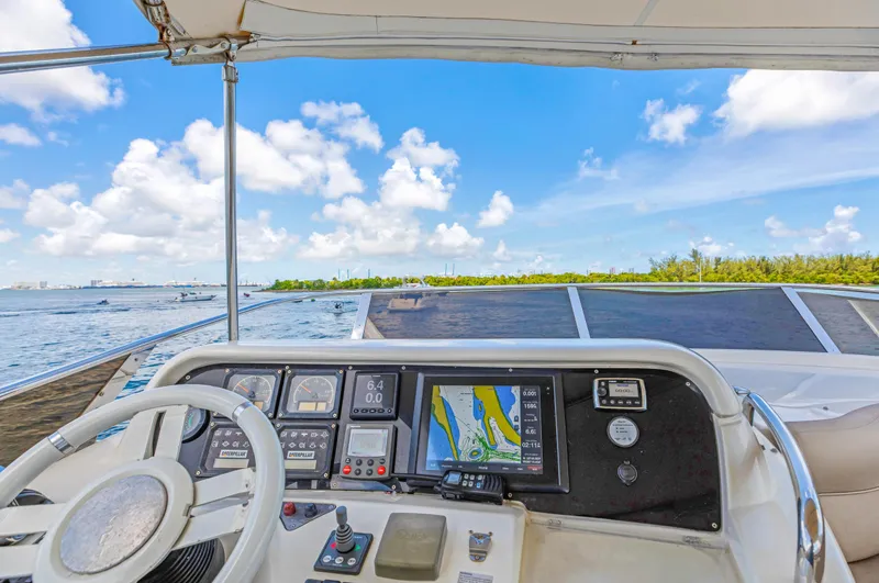  Yacht Photos Pics Cockpit view of 2005 Azimut 55E yacht with navigation system and ocean backdrop.