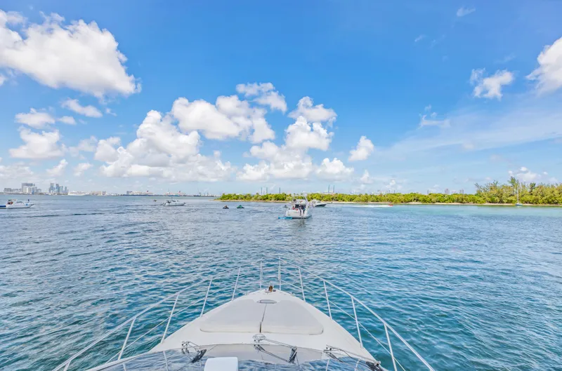  Yacht Photos Pics Azimut 55E yacht cruising on a sunny day, 2005 model, with clear blue skies.
