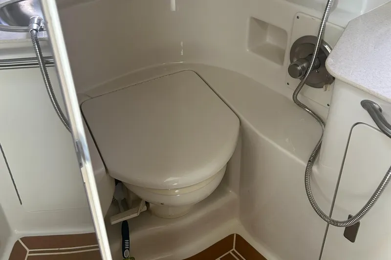 Westwind Yacht Photos Pics 2012 Sea Ray 350 Sundancer bathroom with compact toilet and shower fixtures.
