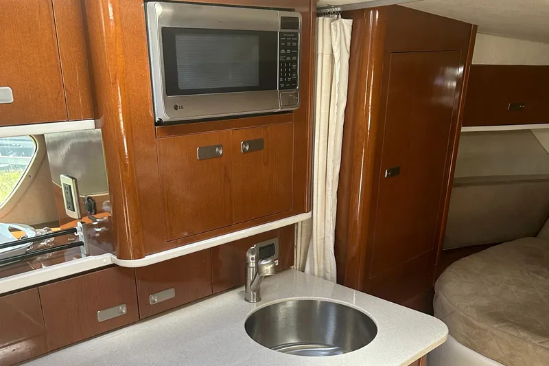 Westwind Yacht Photos Pics Interior of 2012 Sea Ray 350 Sundancer with kitchenette, microwave, and sink.