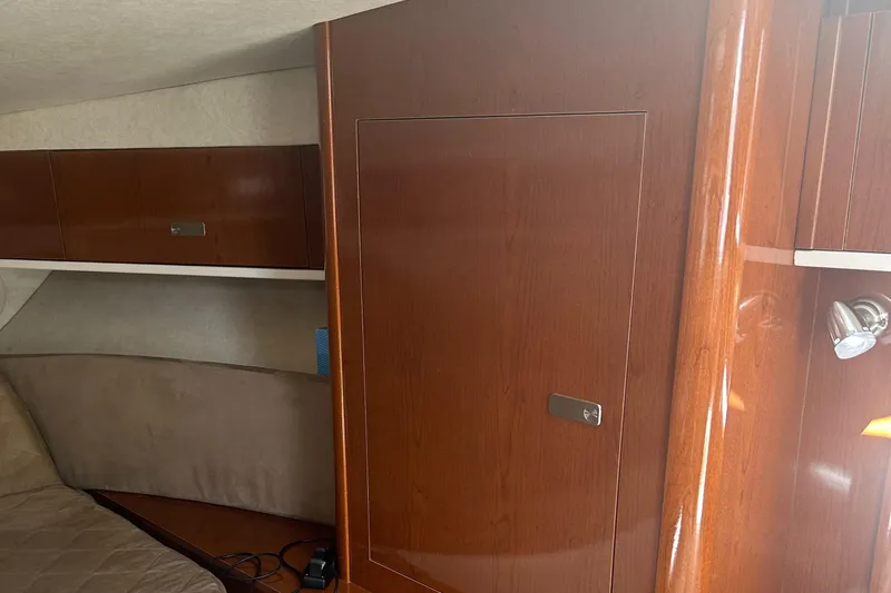 Westwind Yacht Photos Pics Interior cabin of 2012 Sea Ray 350 Sundancer with wooden cabinetry and beige upholstery.