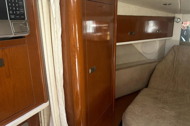 Westwind Yacht Photos Pics Interior of 2012 Sea Ray 350 Sundancer, featuring wood cabinetry and cozy seating area.