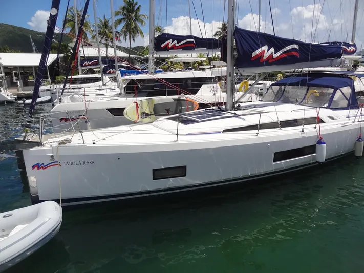 Tabula Rasa Yacht Photos Pics 2020 Beneteau Oceanis 46.1 sailboat docked in a marina with palm trees.