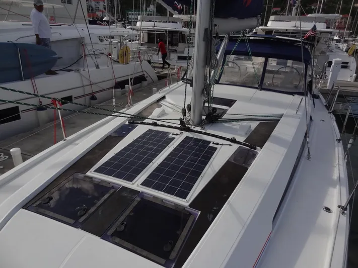 Tabula Rasa Yacht Photos Pics Beneteau Oceanis 46.1 2020 sailboat with solar panels on deck, docked at marina.