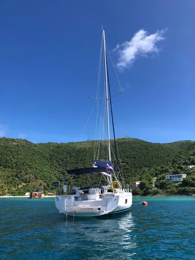 Tabula Rasa Yacht Photos Pics 2020 Beneteau Oceanis 46.1 sailboat anchored in clear blue waters.