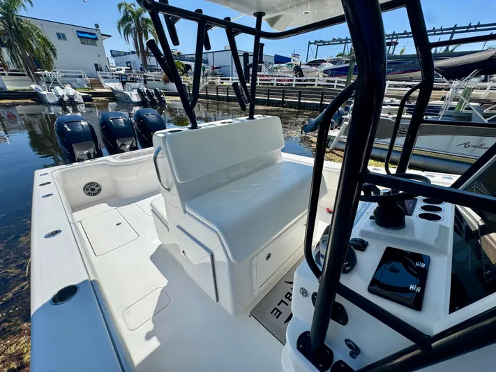  Yacht Photos Pics 2009 Invincible 36 Open Fisherman boat with triple outboard engines at a marina.