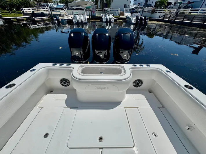  Yacht Photos Pics 2009 Invincible 36 Open Fisherman boat with triple outboard engines at dock.