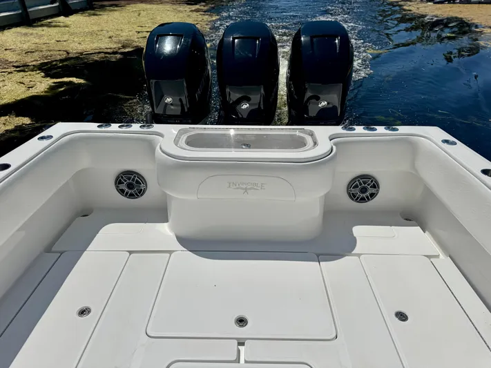  Yacht Photos Pics 2009 Invincible 36 Open Fisherman boat with triple outboard engines on water.