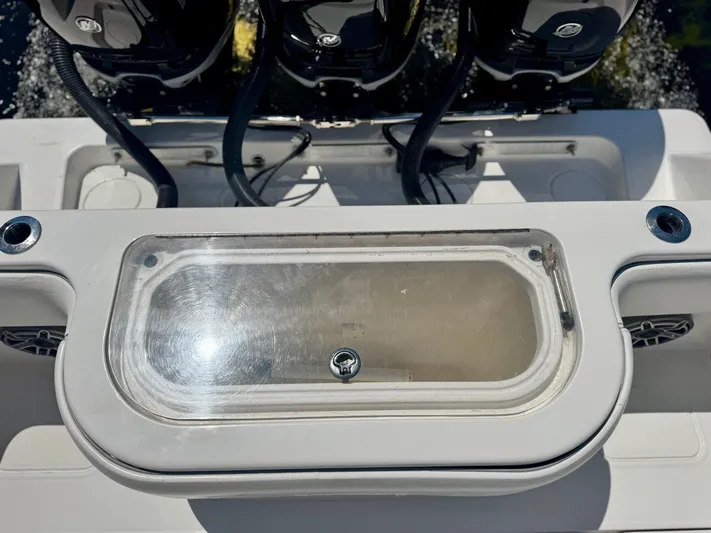  Yacht Photos Pics 2009 Invincible 36 Open Fisherman boat with triple outboard engines and a central storage compartment.