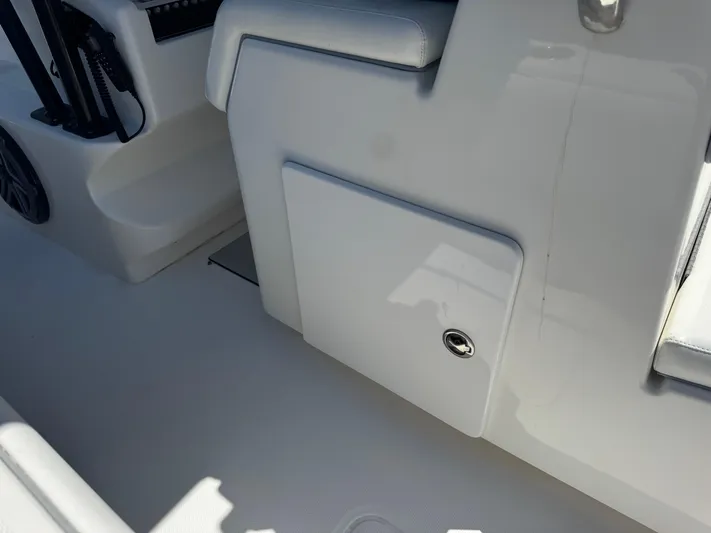  Yacht Photos Pics 2009 Invincible 36 Open Fisherman interior, featuring sleek white seating and storage compartment.