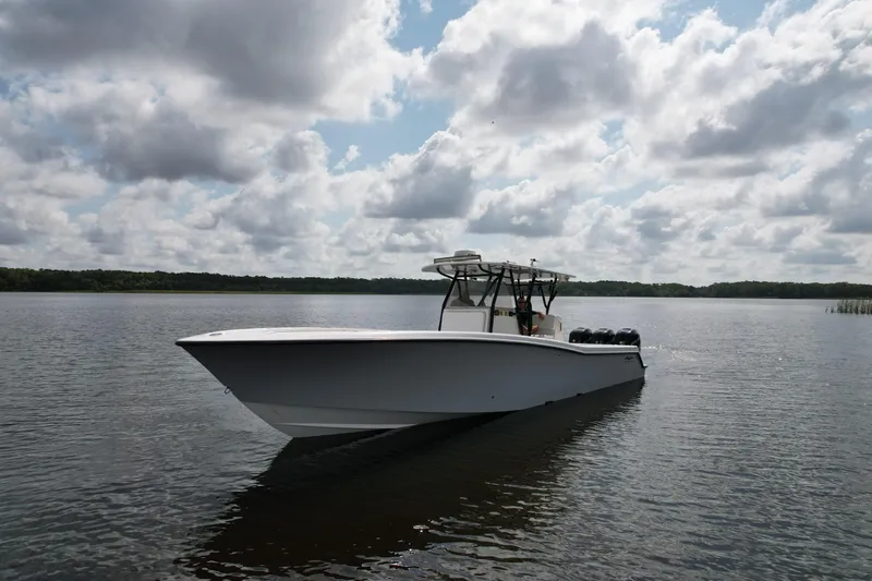  Yacht Photos Pics 2009 Invincible 36 Open Fisherman boat on calm water under cloudy sky.