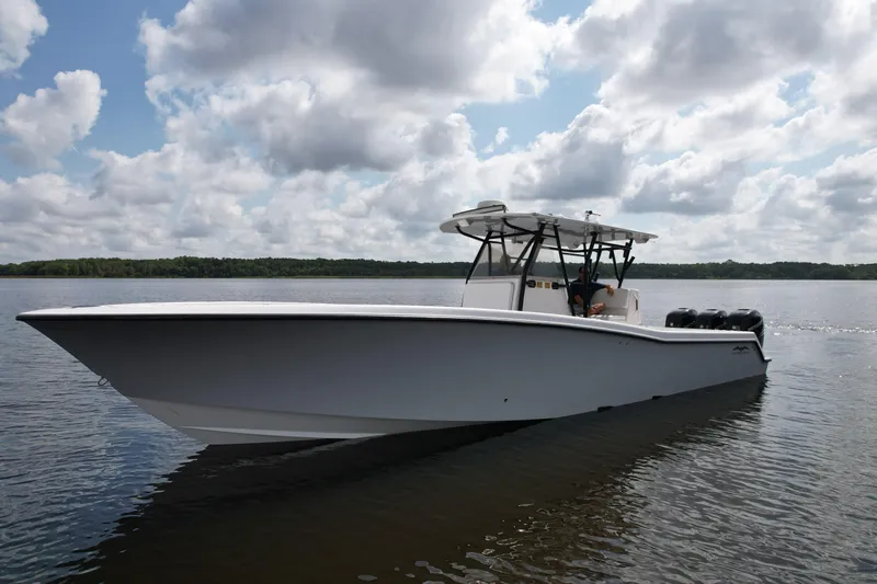  Yacht Photos Pics 2009 Invincible 36 Open Fisherman boat on calm water under cloudy sky.