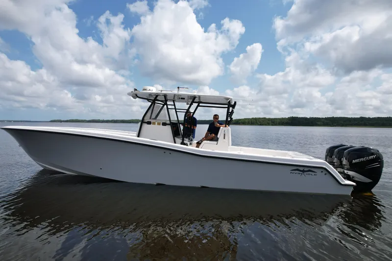  Yacht Photos Pics 2009 Invincible 36 Open Fisherman boat on calm water under cloudy sky.