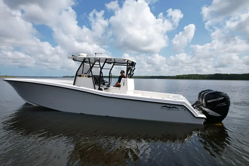  Yacht Photos Pics 2009 Invincible 36 Open Fisherman boat on calm water under a cloudy sky.