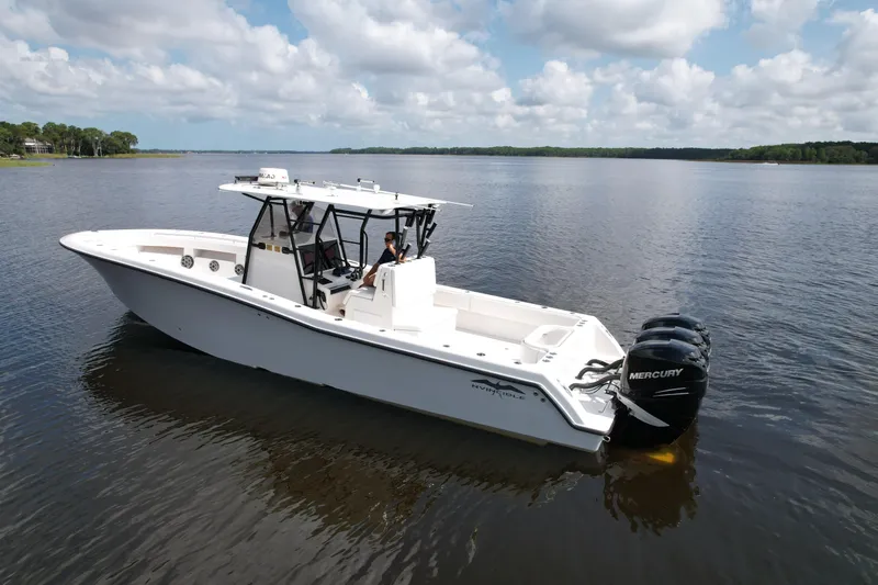  Yacht Photos Pics 2009 Invincible 36 Open Fisherman boat on calm water, featuring Mercury engines.