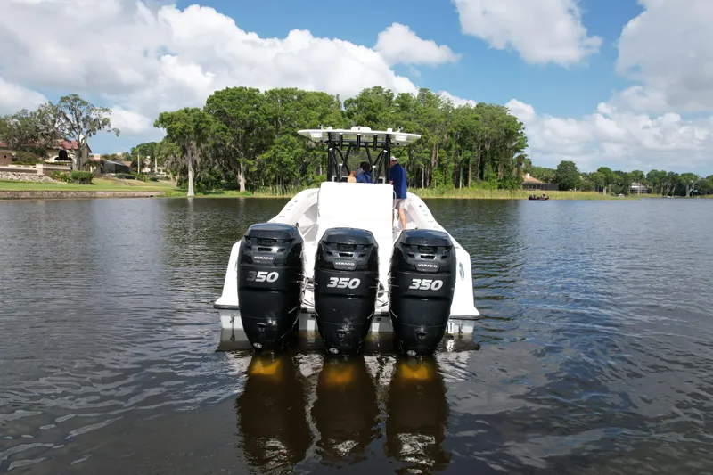  Yacht Photos Pics 2009 Invincible 36 Open Fisherman with triple 350 engines on a calm lake.