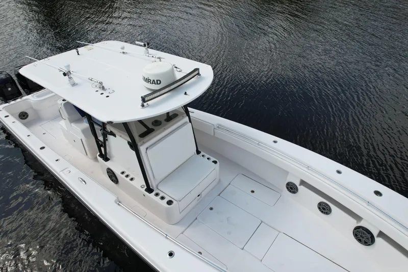  Yacht Photos Pics 2009 Invincible 36 Open Fisherman boat on calm water, showcasing sleek design and spacious deck.