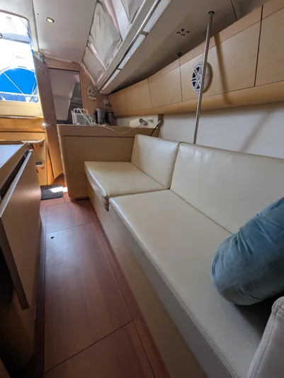 Saga Yacht Photos Pics Interior of 2012 Beneteau First 40 sailboat with beige seating and wooden cabinetry.