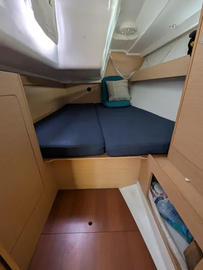 Saga Yacht Photos Pics Cozy cabin interior of 2012 Beneteau First 40 sailboat with blue cushions.