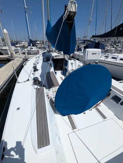 Saga Yacht Photos Pics 2012 Beneteau First 40 sailboat docked at marina, featuring blue sail covers.