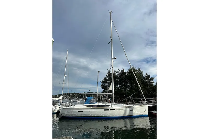 Yacht Photos Pics 2018 Jeanneau Sun Odyssey 479 sailboat docked under cloudy sky.
