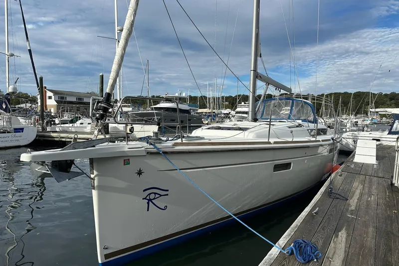  Yacht Photos Pics 2018 Jeanneau Sun Odyssey 479 sailboat docked at marina under cloudy sky.