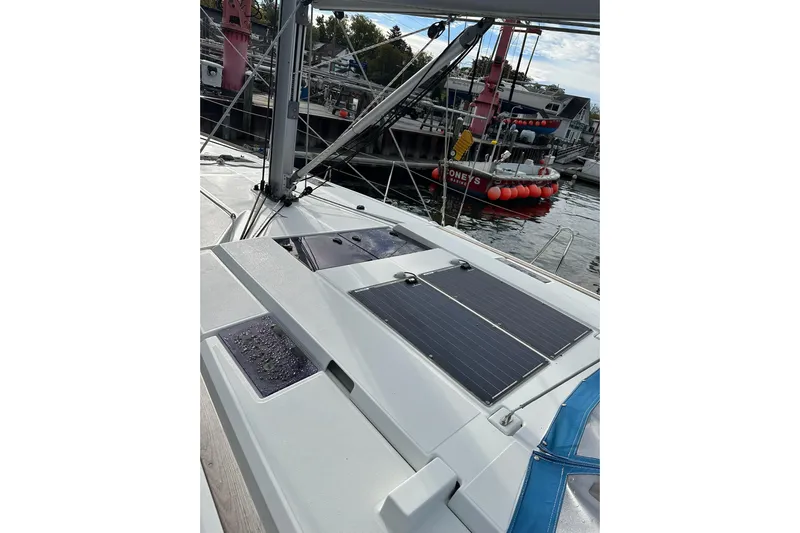  Yacht Photos Pics 2018 Jeanneau Sun Odyssey 479 sailboat with solar panels docked at a marina.