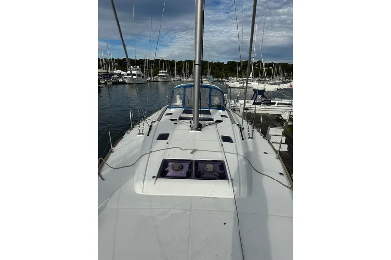  Yacht Photos Pics 2018 Jeanneau Sun Odyssey 479 sailboat docked at a marina, showcasing its deck and mast.
