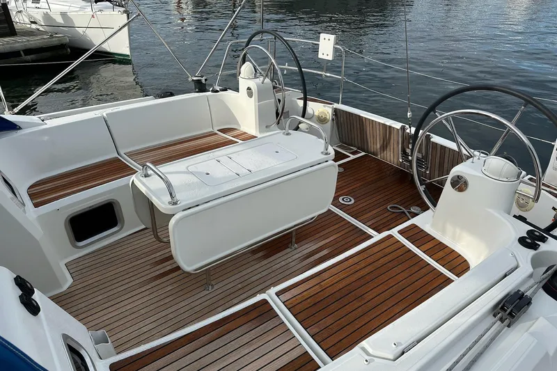  Yacht Photos Pics Cockpit of 2018 Jeanneau Sun Odyssey 479 sailboat with dual steering wheels and teak flooring.