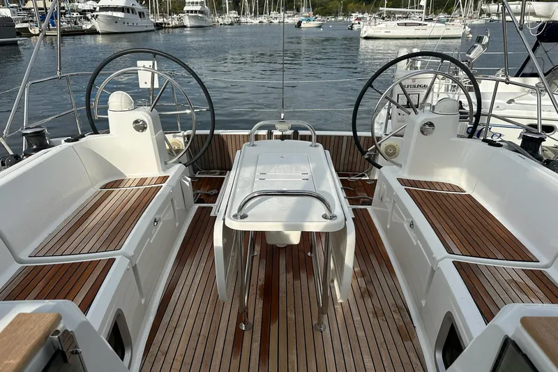  Yacht Photos Pics 2018 Jeanneau Sun Odyssey 479 cockpit with dual steering wheels and wooden deck.
