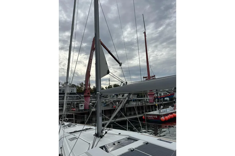  Yacht Photos Pics 2018 Jeanneau Sun Odyssey 479 sailboat docked at marina under cloudy sky.