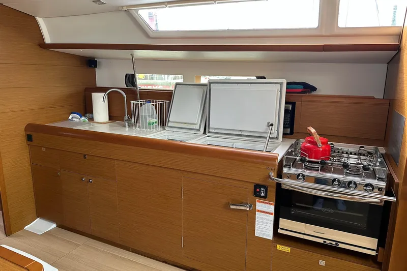  Yacht Photos Pics Modern kitchen in 2018 Jeanneau Sun Odyssey 479 yacht with stove and sink.
