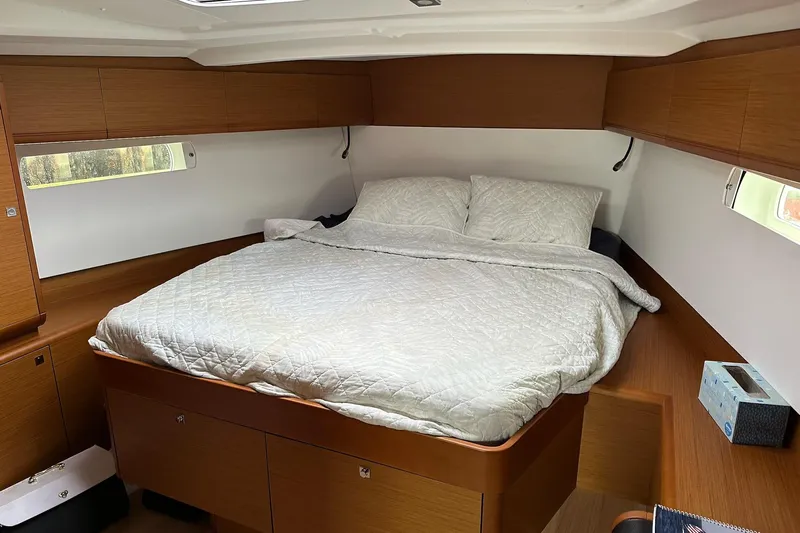  Yacht Photos Pics Cozy cabin interior of 2018 Jeanneau Sun Odyssey 479 sailboat with double bed.