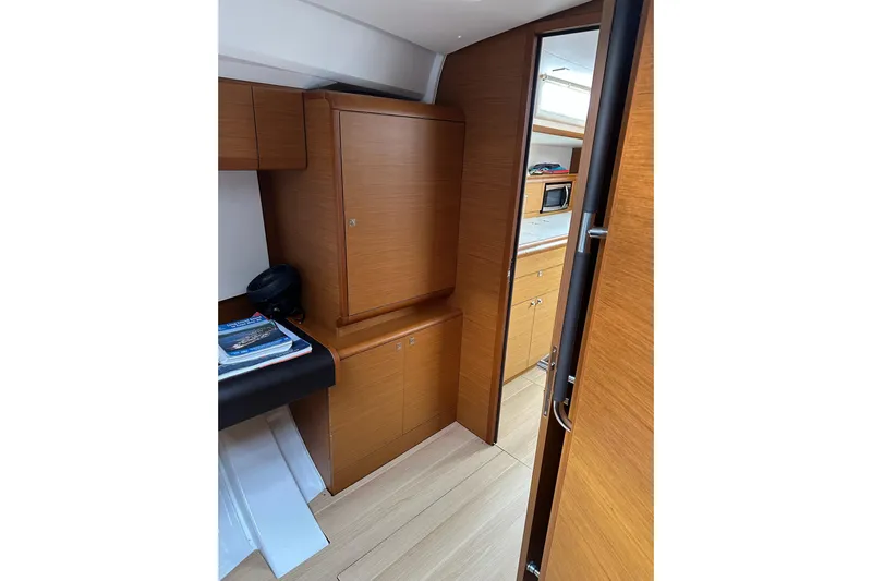 Yacht Photos Pics Interior of 2018 Jeanneau Sun Odyssey 479 yacht, featuring wooden cabinetry and modern design.