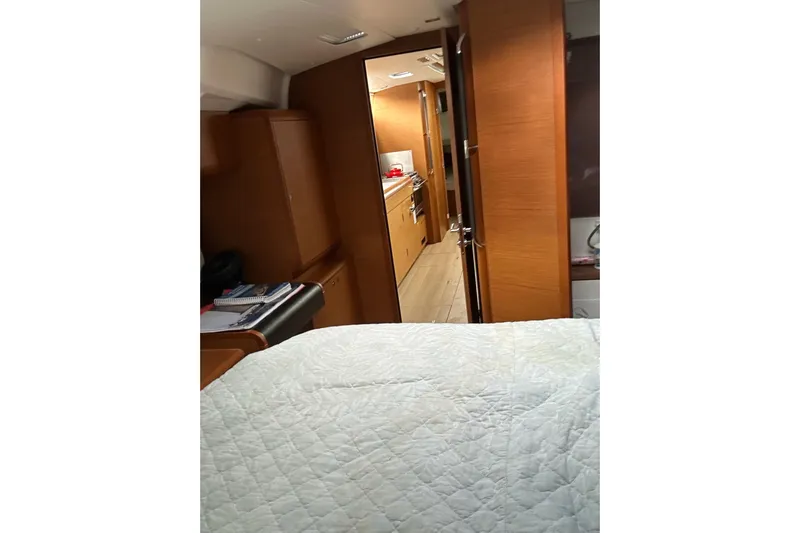  Yacht Photos Pics Interior of 2018 Jeanneau Sun Odyssey 479 yacht, featuring cozy cabin and galley.