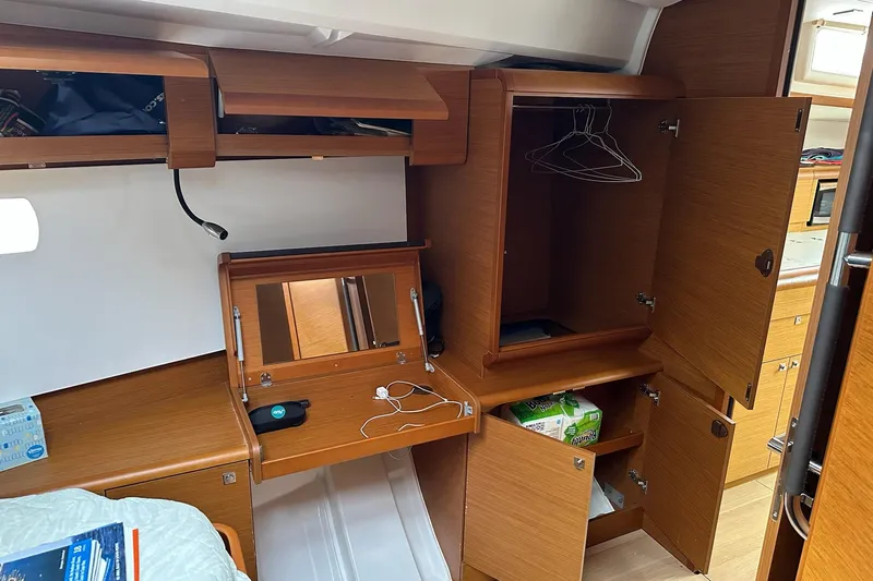  Yacht Photos Pics Interior cabin of 2018 Jeanneau Sun Odyssey 479 yacht with wooden cabinetry and storage.