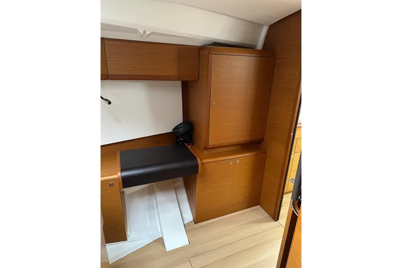  Yacht Photos Pics Interior of 2018 Jeanneau Sun Odyssey 479 yacht with wooden cabinetry and seating.