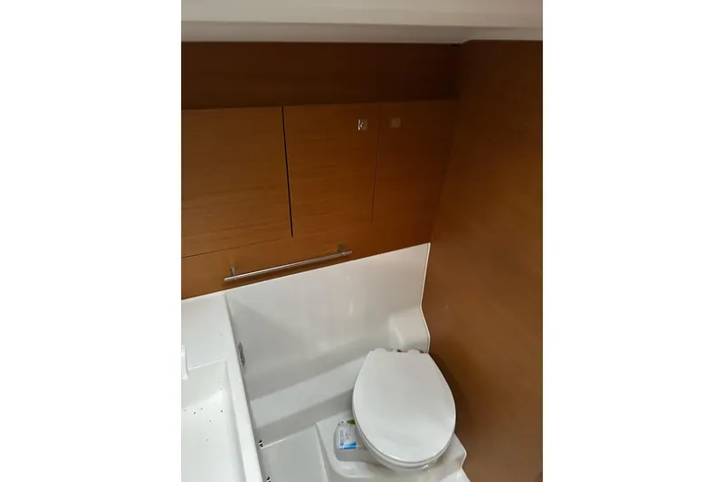  Yacht Photos Pics 2018 Jeanneau Sun Odyssey 479 yacht bathroom with wooden cabinetry and modern toilet.