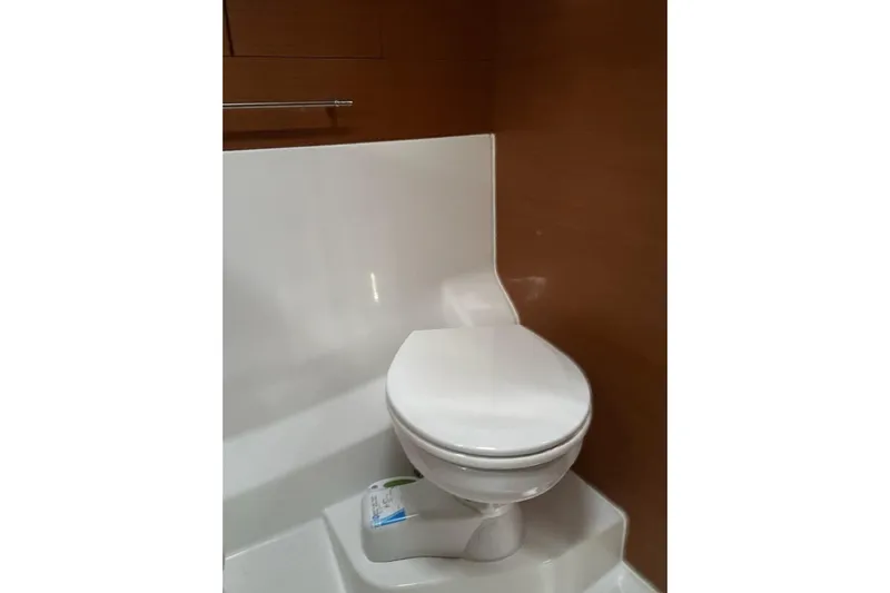  Yacht Photos Pics Toilet in 2018 Jeanneau Sun Odyssey 479 yacht bathroom, featuring sleek design and wood paneling.