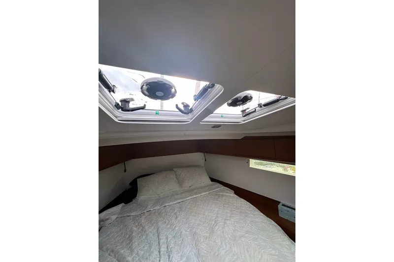  Yacht Photos Pics Cozy cabin interior of 2018 Jeanneau Sun Odyssey 479 with skylights and bed.