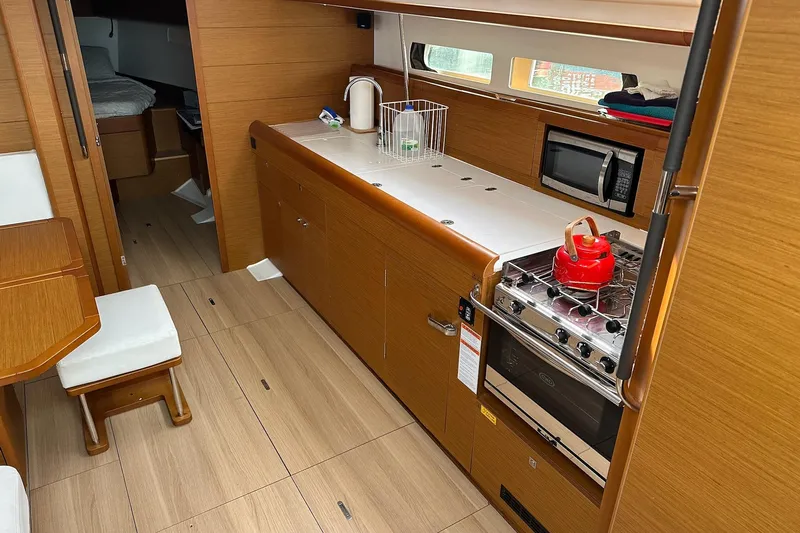  Yacht Photos Pics Interior of 2018 Jeanneau Sun Odyssey 479 yacht with modern kitchen amenities.