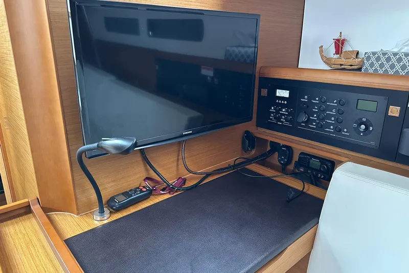  Yacht Photos Pics Interior of 2018 Jeanneau Sun Odyssey 479 yacht with navigation equipment and TV.