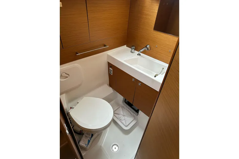  Yacht Photos Pics Bathroom interior of 2018 Jeanneau Sun Odyssey 479 yacht, featuring modern sink and toilet.